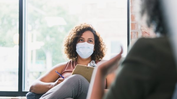 Female counselor wears mask during session