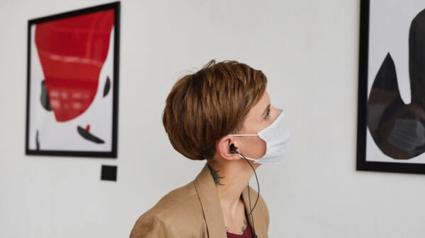 Woman Wearing Mask Looking at Modern Art at Exhibition