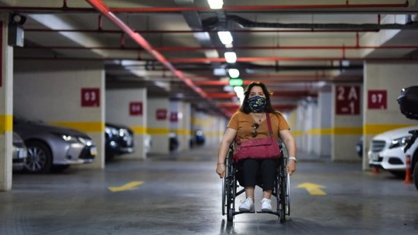 Woman in wheelchair in parking lot