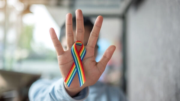 young woman with Rainbow ribbon LGBTQ for Lesbian, Gay, Bisexual, Transgender and Queer community pride concept