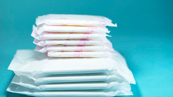 Sanitary pads and absorbent sheets on blue background