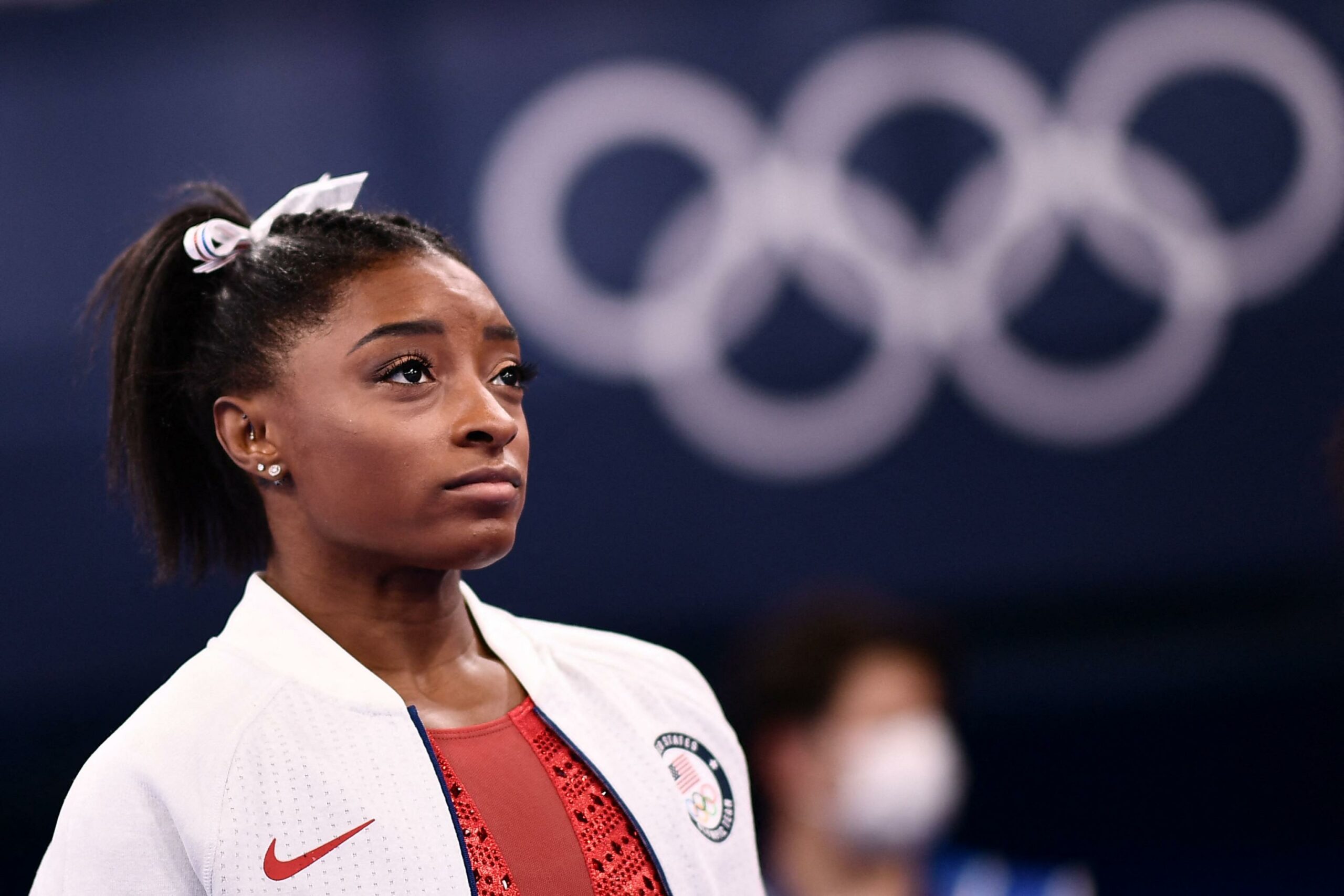 USA's Simone Biles looks on during the artistic gymnastics women's team final during the Tokyo 2020 Olympic Games at the Ariake Gymnastics Centre in Tokyo on July 27, 2021. (Photo by Loic VENANCE / AFP)