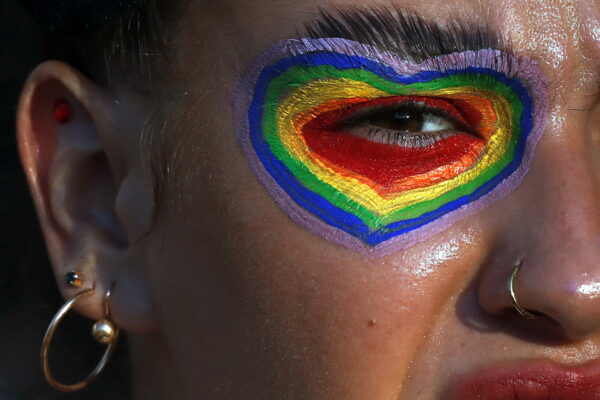 epa09414323 A Romanian woman, member of the LGBT (lesbian, gay, bisexual, and transgender) community of Bucharest marches during the Gay Pride 2021 parade, in downtown Bucharest, Romania, 14 August 2021, as part of the worldwide Gay Pride celebrations.  EPA/ROBERT GHEMENT