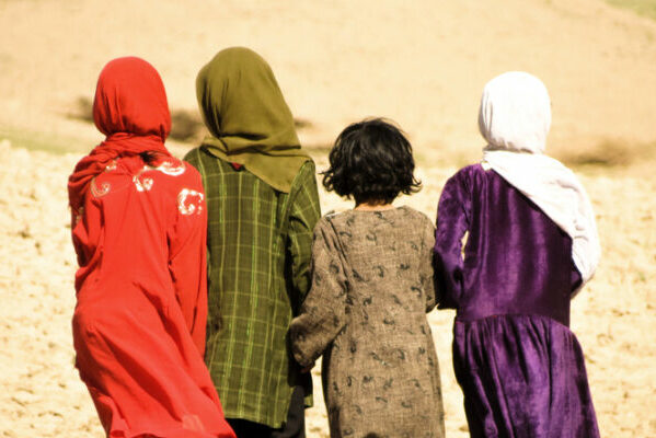 Chagcharan, Afghanistan - August 25, 2012: Four Afghanistan girls walking in the mountains.
