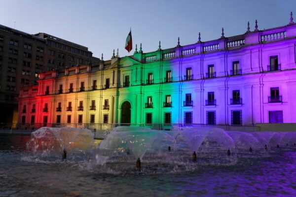 epa09628453 A handout photo made available by the Chilean Presidency shows the Palacio de la Moneda, seat of the Government, illuminated with the colors of the LGTBIQ + flag, after the approval of same-sex marriage in the country, in Santiago, Chile, 07 December 2021.  EPA/Chilean Presidency / HANDOUT  HANDOUT EDITORIAL USE ONLY/NO SALES