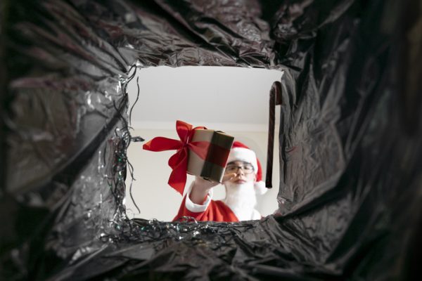 santa throws gifts in the trash. view from the trash bag. end of Christmas holidays. spoiled christmas.