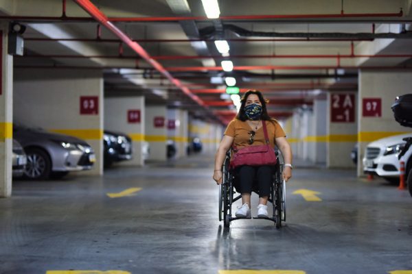 Woman in wheelchair in parking lot