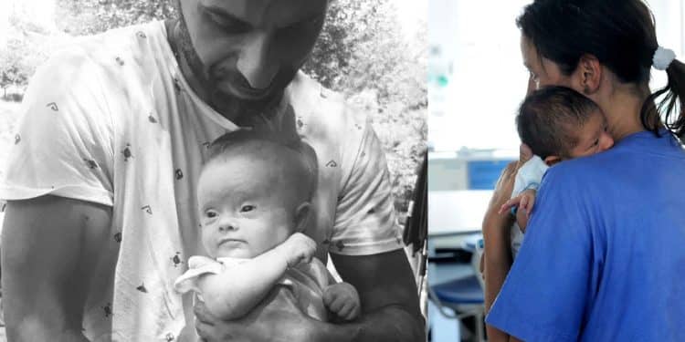 A sx Luca Trapanese stringe la figlia Alba, ancora molto piccola. A dx un infermiera del reparto maternità con un neonato